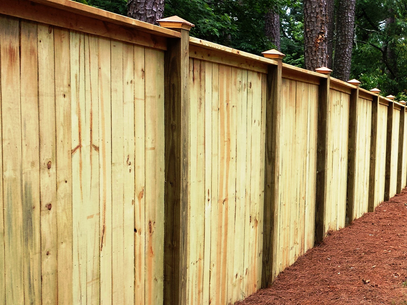 Wood privacy fence with copper cap and trim